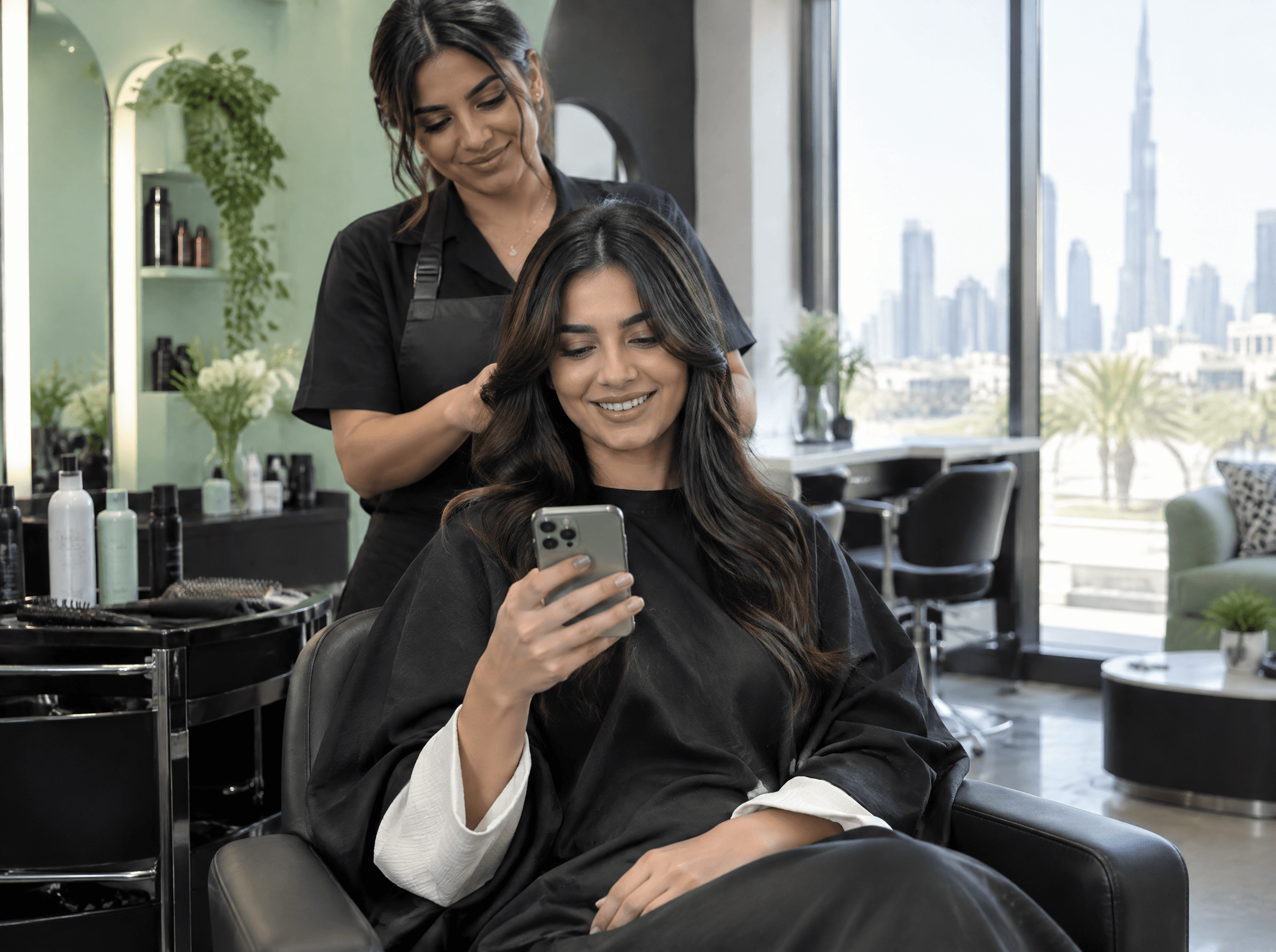 Customer smiling at her phone after booking a salon appointment